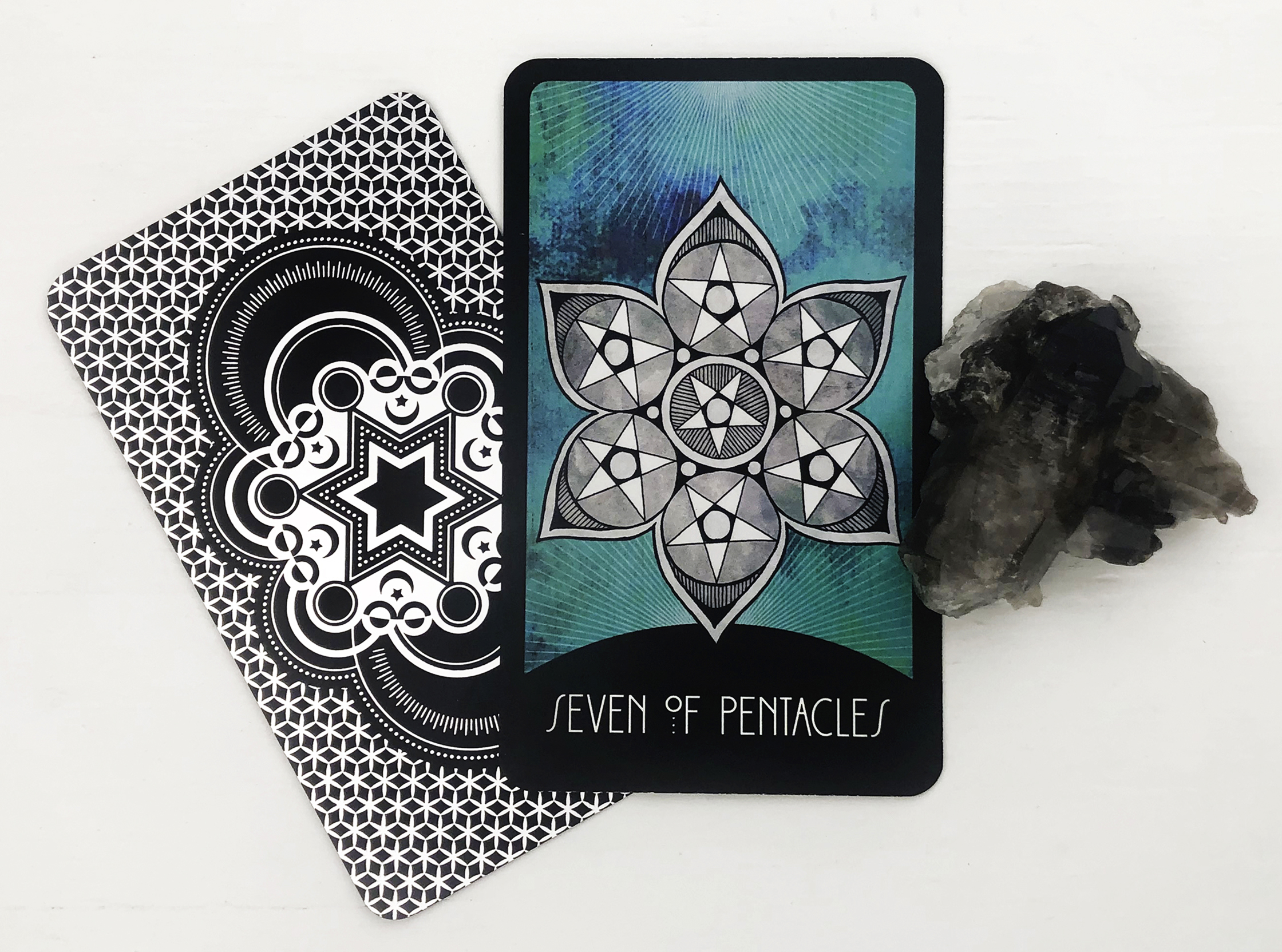 The Seven of Pentacles Tarot Card